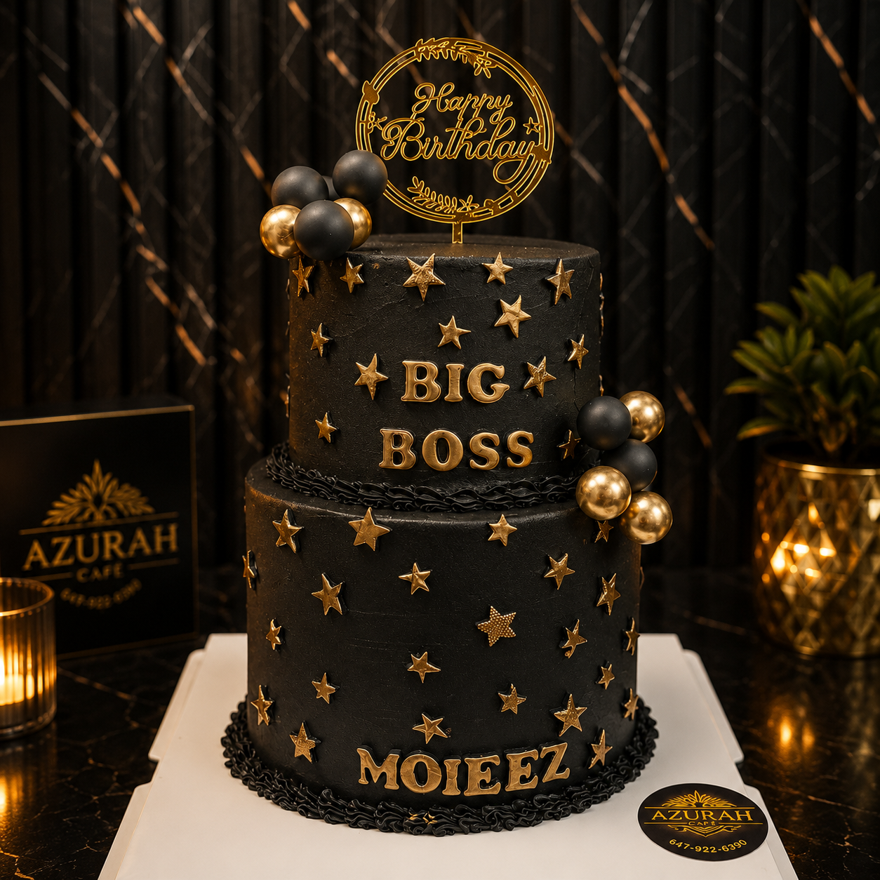 Two-tier black and gold custom birthday cake with gold stars
